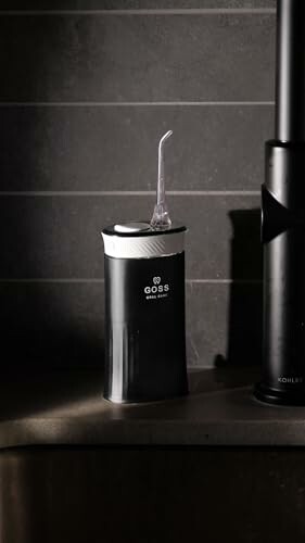 Black water flosser on a countertop, ready for use!